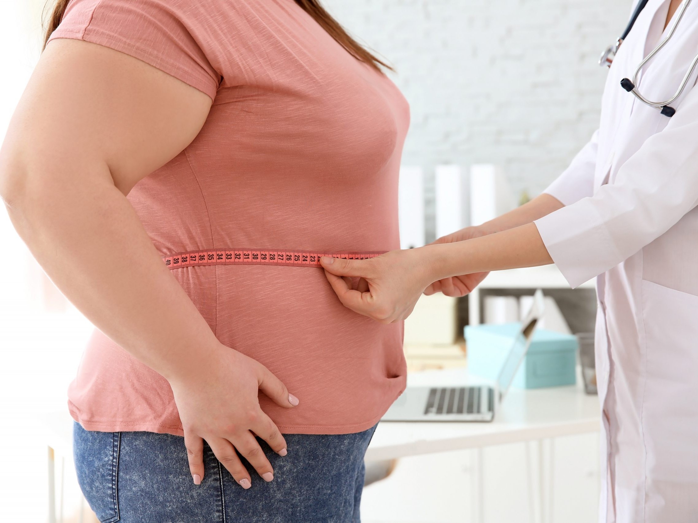 overweight_women_getting_her_waist_measured