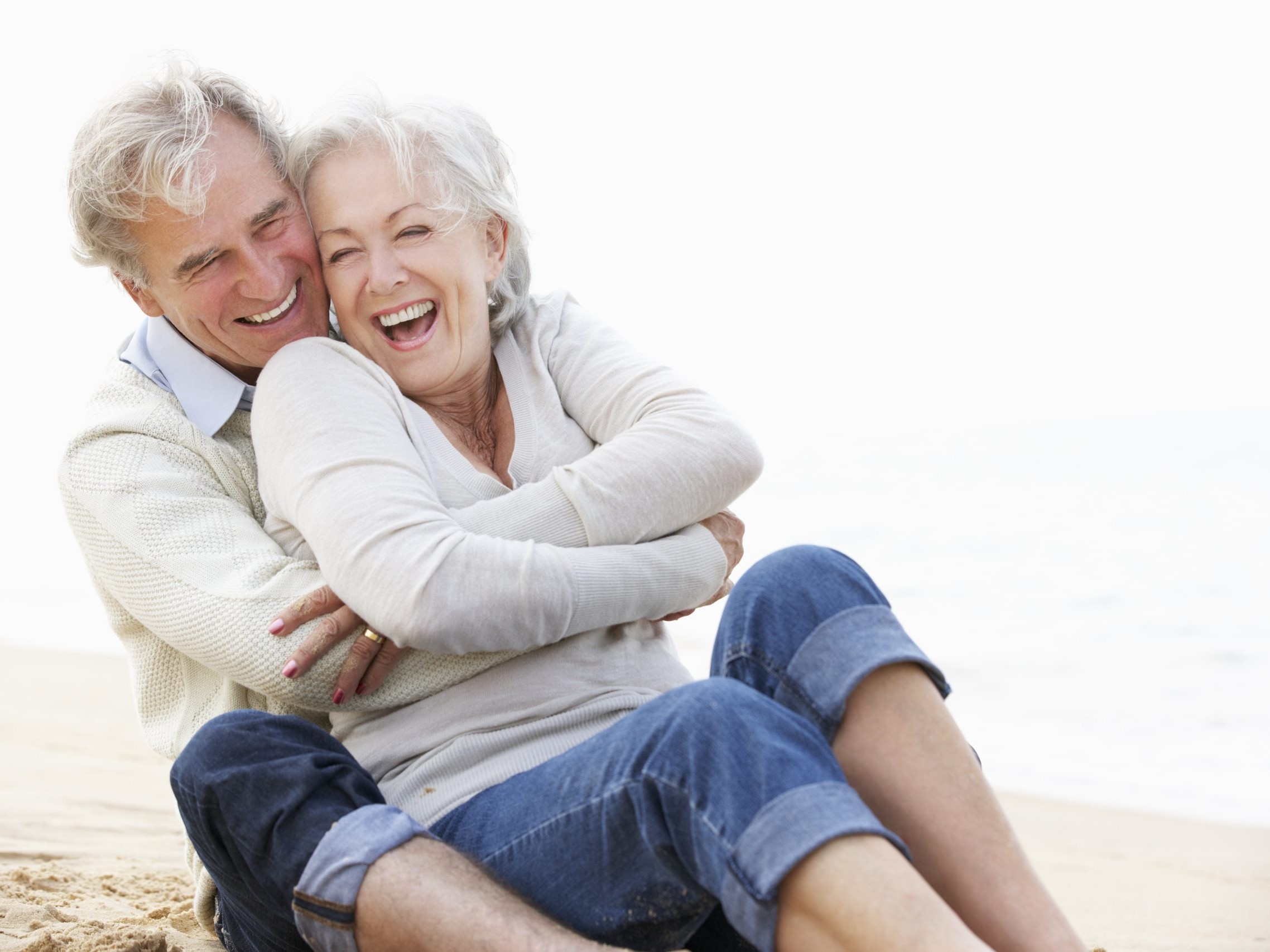 elderly_couple_smiling_on_beach